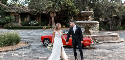 couples wedding photoshoot next to red convertible classic car