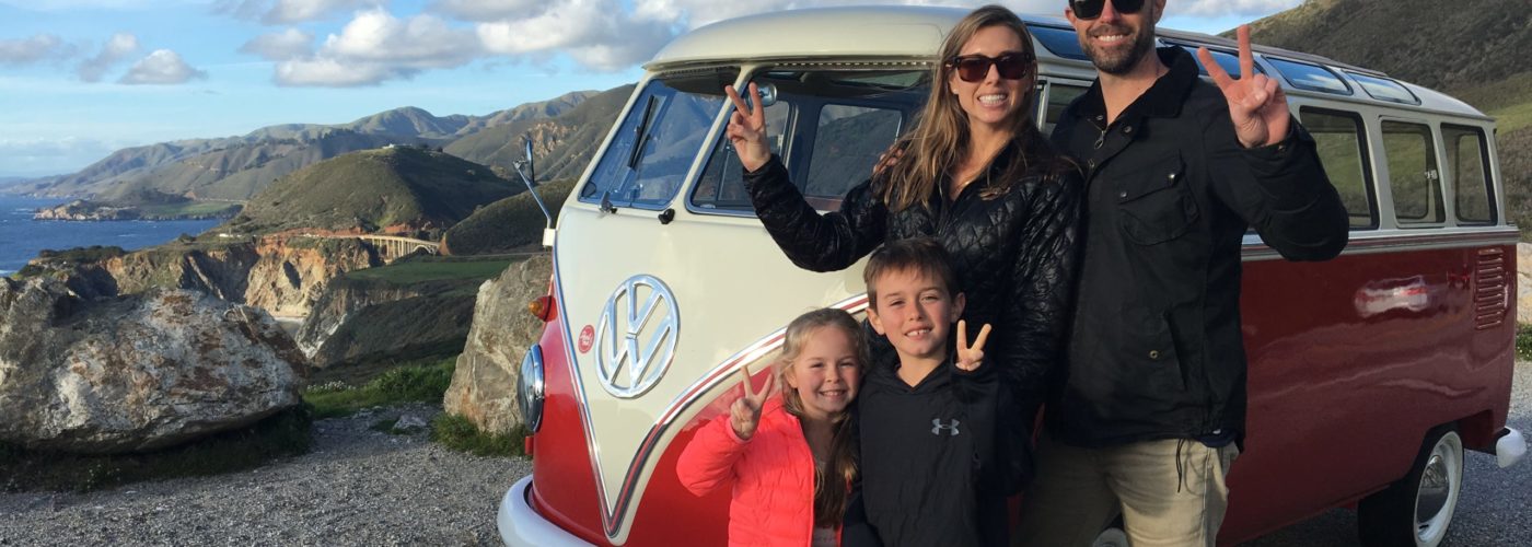 family outside rental volkswagen bus