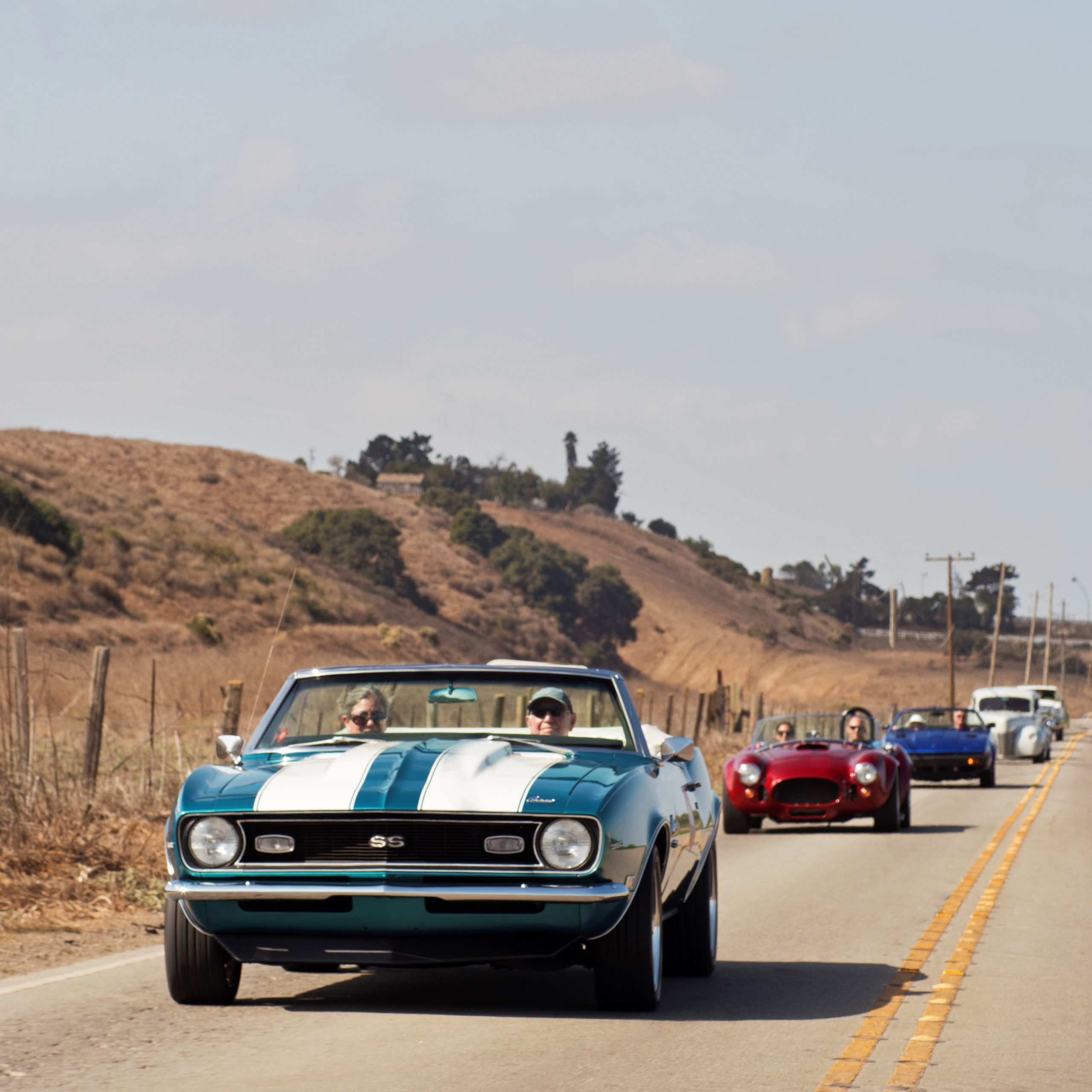 blue camaro on road rally