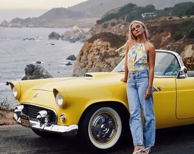woman standing infront of classic car in big sur