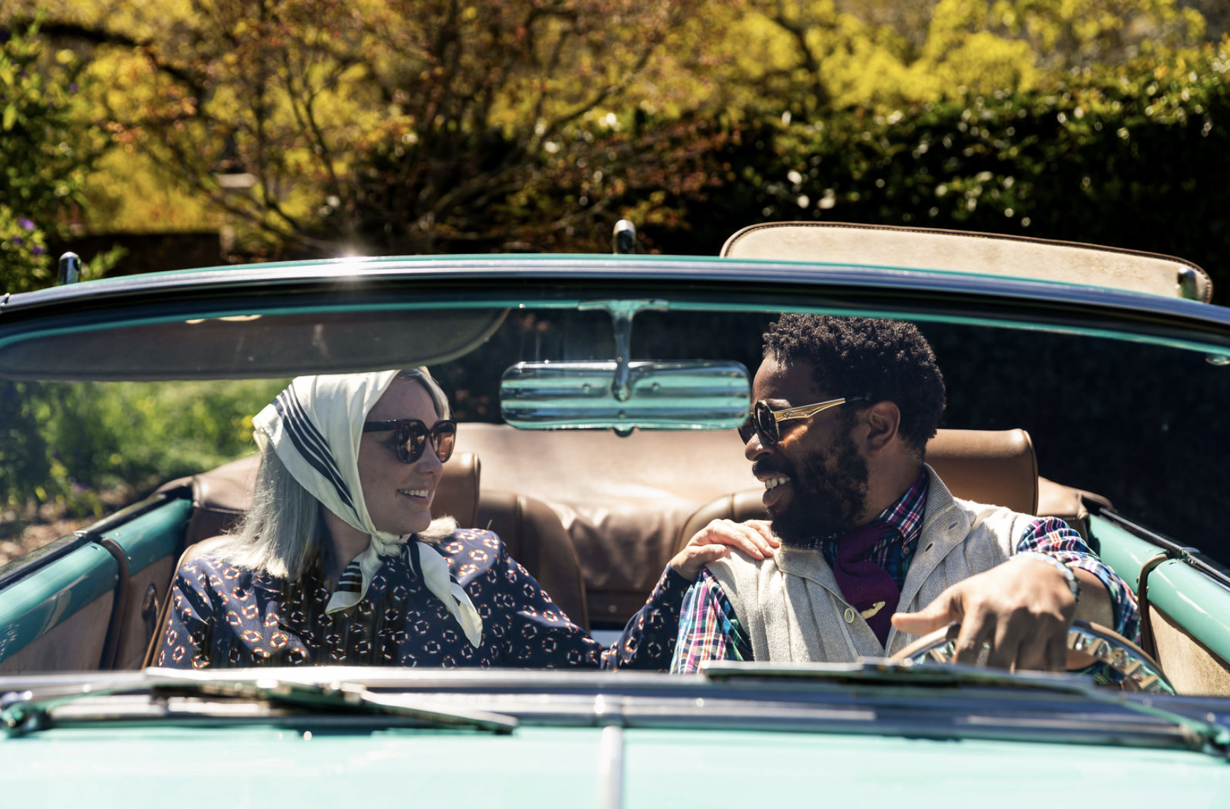 man and woman riding in their monterey touring vehicles classic car